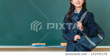 High school and junior high school girls smiling in the classroom with their school bags. High school and junior high school girls smiling in the classroom with their school bags. 142445176
