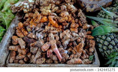 A Large Pile of Fresh Turmeric and Ginger Rhizomes in Market A Large Pile of Fresh Turmeric and Ginger Rhizomes in Market 142445275