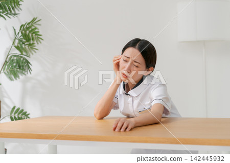 一位女士在美容院裡,表情沮喪。 一位女士在美容院裡,表情沮喪。 142445932