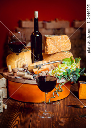 Cheese and wine on a dark table. Cheese and wine on a dark table. 142446695