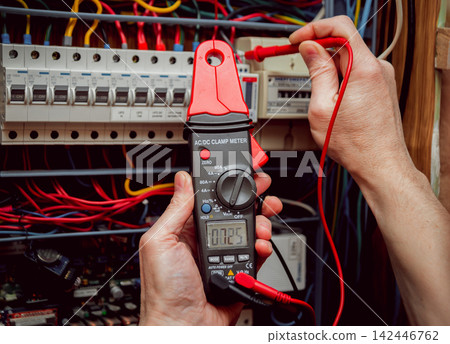 Electrical equipment. Tester in the hands. Electrical equipment. Tester in the hands. 142446762