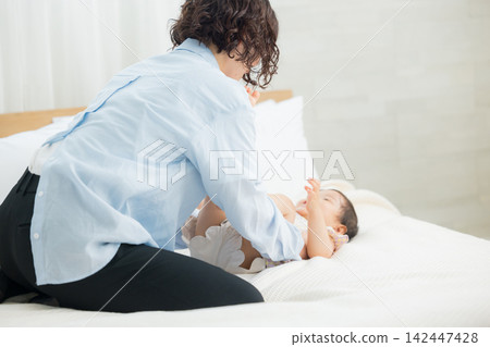 A mother holding her one-year-old daughter. A mother holding her one-year-old daughter. 142447428