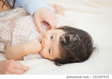 A mother holding her one-year-old daughter. A mother holding her one-year-old daughter. 142447435