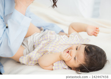 A mother holding her one-year-old daughter. A mother holding her one-year-old daughter. 142447438