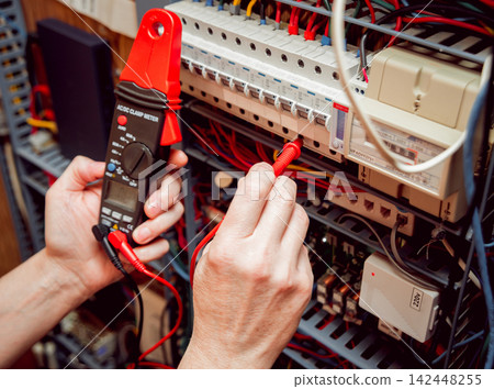 Electrical equipment. Tester in the hands. Electrical equipment. Tester in the hands. 142448255