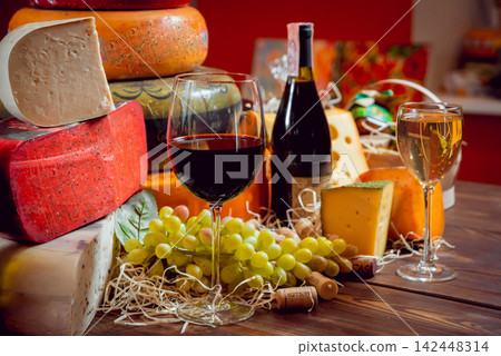 Cheese and wine on a dark table. Cheese and wine on a dark table. 142448314