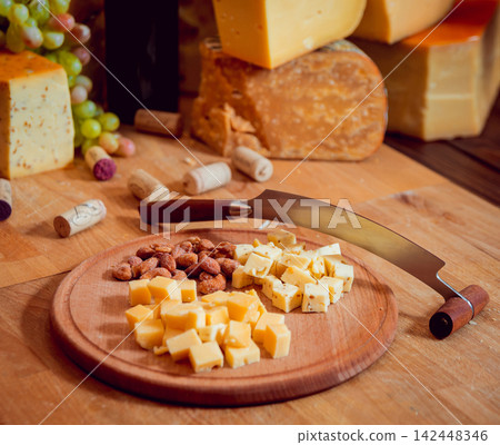Cheese and wine on a dark table. Cheese and wine on a dark table. 142448346