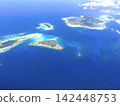 Views of the Okinawan Islands from the air - Emerald green coral reefs and a group of outlying islands 142448753