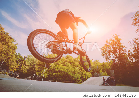 Boy jumping with his bmx in the park. Boy jumping with his bmx in the park. 142449189