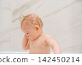 Cute Baby Touching Wet Hair During Bath Time 142450214
