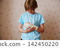 Upset person looking at broken arm in cast and medical sling 142450220