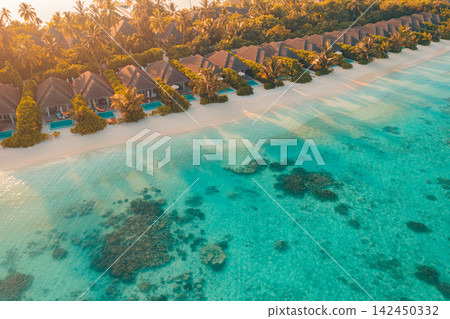 Gorgeous aerial sweep overwater villas lining vivid azure Maldives lagoon tropical reef lush island resort. Luxury travel destination landscape scenic. Exotic honeymoon getaway vista wallpaper Gorgeous aerial sweep overwater villas lining vivid azure Maldives lagoon tropical reef lush island resort. Luxury travel destination landscape scenic. Exotic honeymoon getaway vista wallpaper 142450332