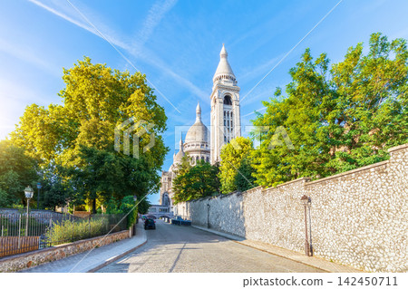 Side view of Sacred Heart Basilica in Montmartre at beautiful sunrise, Paris, France Side view of Sacred Heart Basilica in Montmartre at beautiful sunrise, Paris, France 142450711