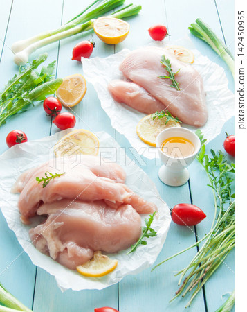 Fresh raw chicken breast meat on parchment paper with greens, healthy vegetables and fruits Fresh raw chicken breast meat on parchment paper with greens, healthy vegetables and fruits 142450955