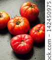 Red ripe fresh organic tomatoes on background splashed with water, healthy nutritious vegetables 142450975
