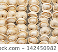 Raw homemade handmade russian pelmeni dumplings rows sprinkled with flour on metal tray 142450982