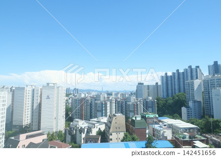 Cityscape of Seoul featuring modern residential buildings and mountain skyline Cityscape of Seoul featuring modern residential buildings and mountain skyline 142451656