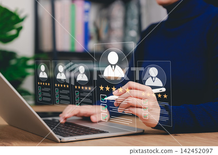 Candidate Review and Talent Evaluation Concept. HR manager reviewing candidate profiles with ratings and checklists. applicant screening, talent assessment, hiring decisions, recruitment quality 142452097