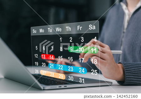 Calendar Scheduling and Time Management Concept. Woman using laptop and stylus with virtual calendar interface representing appointment planning, task scheduling, deadline tracking organized workflow 142452160