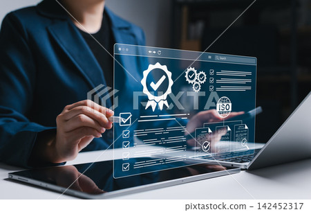 ISO certification and compliance audit management concept. Businesswoman reviewing checklists, approval documents, and quality verification, representing standards control and certification workflow. ISO certification and compliance audit management concept. Businesswoman reviewing checklists, approval documents, and quality verification, representing standards control and certification workflow. 142452317