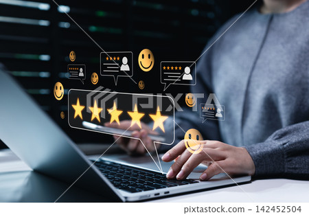 Customer Satisfaction and Five Star Review Concept. Woman using laptop with rating icons, review cards, and smile symbols representing positive feedback, service quality, trusted customer experience, Customer Satisfaction and Five Star Review Concept. Woman using laptop with rating icons, review cards, and smile symbols representing positive feedback, service quality, trusted customer experience, 142452504
