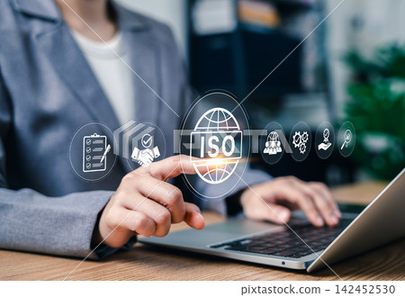 ISO standard certification and quality management concept. Businesswoman typing on laptop to control international compliance, corporate audit checklist, global business workflow, assurance policy ISO standard certification and quality management concept. Businesswoman typing on laptop to control international compliance, corporate audit checklist, global business workflow, assurance policy 142452530