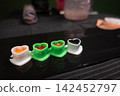 Tattoo artist supplies with colorful inks in heart cups 142452797