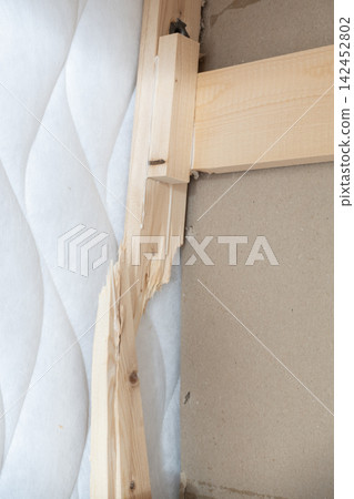 Broken wooden bed frame showing damaged timber and splintered wood structure Broken wooden bed frame showing damaged timber and splintered wood structure 142452802
