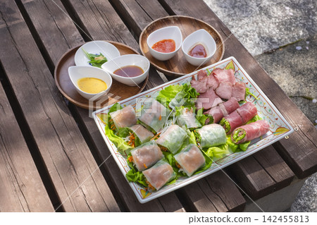 Fresh spring rolls and ham-wrapped salad Fresh spring rolls and ham-wrapped salad 142455813