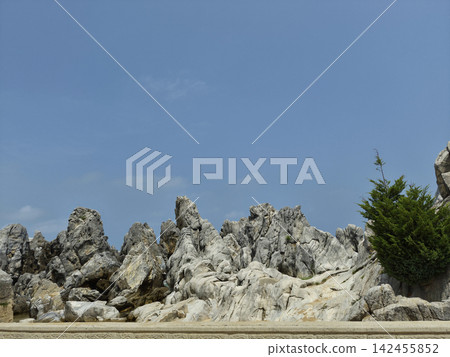 It is a landscape featuring strangely shaped rocks and cliffs. It is a landscape featuring strangely shaped rocks and cliffs. 142455852