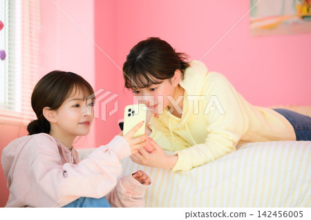 Two women watching smaho Two women watching smaho 142456005