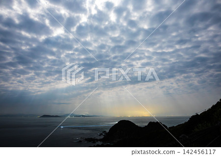 Clouds spread across the night sky, and a panoramic view of the tranquil strait. Clouds spread across the night sky, and a panoramic view of the tranquil strait. 142456117