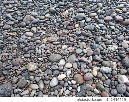 Top view of floor with round basalt rocks 142456219