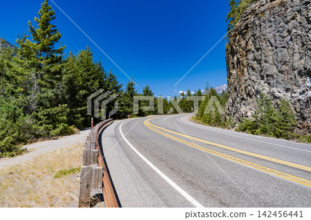 Road to Diablo lake with forest landscape. Landscape of rocky road. Travel destination. Landscape route to North Cascades National Park. Scenic nature. North Cascades nation park Road to Diablo lake with forest landscape. Landscape of rocky road. Travel destination. Landscape route to North Cascades National Park. Scenic nature. North Cascades nation park 142456441