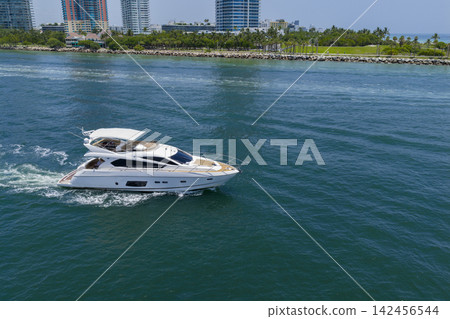Motorboat sailing at sea. Luxury charter yacht in sea. Motor yacht luxury vessel. Sea motor boat. Sea summer vacation. Aerial motorboat. Yacht boat tour. Luxury boat yachting. Summer escape Motorboat sailing at sea. Luxury charter yacht in sea. Motor yacht luxury vessel. Sea motor boat. Sea summer vacation. Aerial motorboat. Yacht boat tour. Luxury boat yachting. Summer escape 142456544