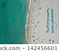 Sea relax under beach umbrella. Travel to sea. Aerial top view of sand beach with crystal clear turquoise water. Summer vacation in paradise. Beach vacation at sea in summer. Seychelles resort 142456601