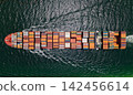 Shipping logistics. Commercial shipping. Top view. Cargo ship in sea, aerial view. Freight container loaded on cargo vessel. Aerial cargo ship with container. Cargo business. Container ship 142456614