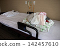 A pile of beds and bedding in a room at a nursing home. 142457610