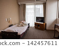 A pile of beds and bedding in a room at a nursing home. 142457611