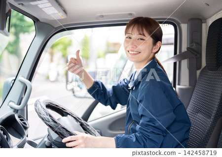 Woman driving a truck Woman driving a truck 142458719