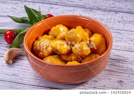 Pickled yellow patisson squash in terracotta bowl with fresh garlic and tomatoes on rustic wooden table Pickled yellow patisson squash in terracotta bowl with fresh garlic and tomatoes on rustic wooden table 142458924