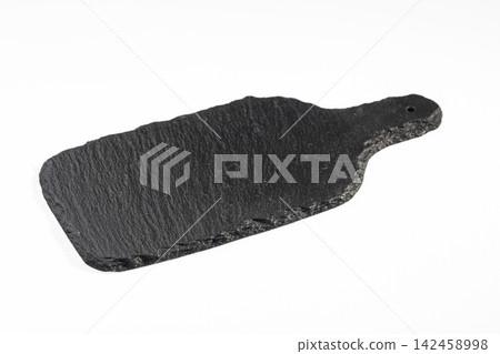 Black slate serving board with natural edge and hole on white background Black slate serving board with natural edge and hole on white background 142458998
