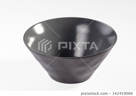 Black ceramic bowl with speckled texture on white background Black ceramic bowl with speckled texture on white background 142459066