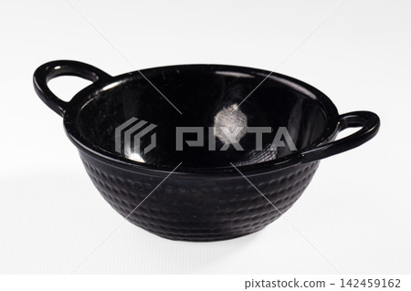 Black textured colander with dual handles on white background Black textured colander with dual handles on white background 142459162