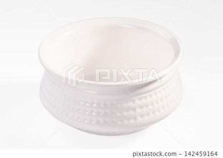White ceramic bowl with textured exterior on white background 142459164