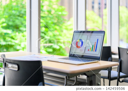 A laptop computer placed on a desk by the window. A laptop computer placed on a desk by the window. 142459506