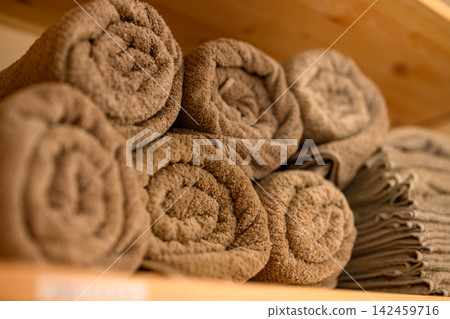 A stack of clean bath towels on a shelf. A stack of clean bath towels on a shelf. 142459716