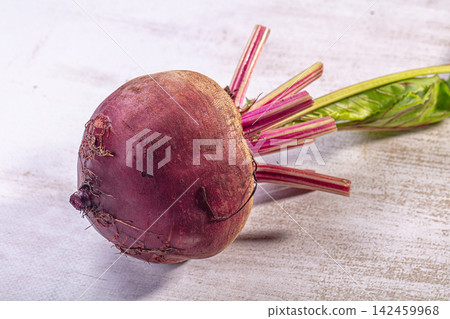 Fresh beetroot with green leaves on light textured surface Fresh beetroot with green leaves on light textured surface 142459968