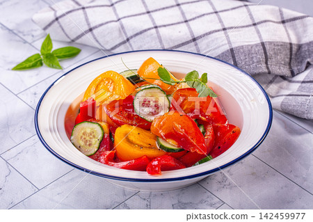 Fresh vegetable salad with tomatoes cucumbers and peppers in white bowl Fresh vegetable salad with tomatoes cucumbers and peppers in white bowl 142459977