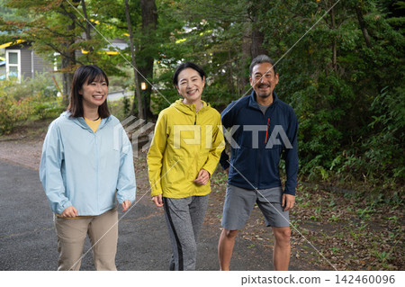Three friends standing together on a plateau, running and jogging. Three friends standing together on a plateau, running and jogging. 142460096